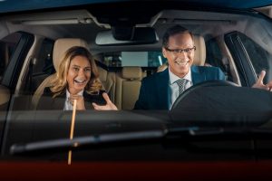 Man and Woman sitting in Car Smiling