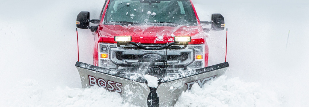 red ford truck plowing snow