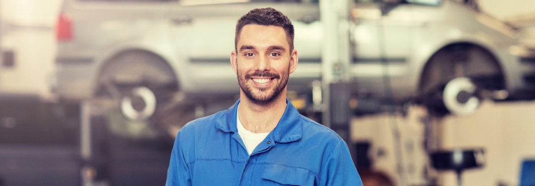 Happy mechanic in a vehicle shop