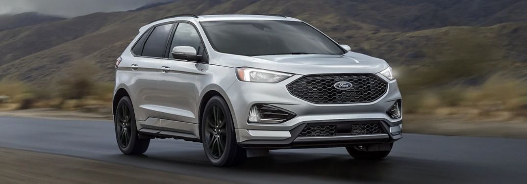 A silver 2021 Ford Edge on the road.