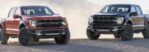 Red and Black 2021 Ford F-150 parked next to each other.