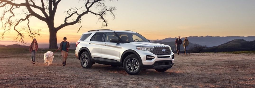 A 2021 Ford Explorer parked in the desert area near a tree.