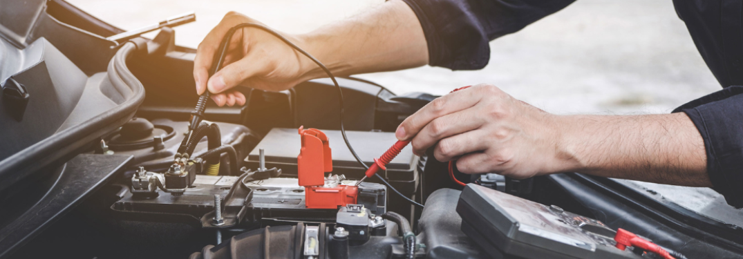 Mechanic checking the vehicle's battery