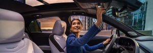 a woman in driving seat opening sunroof of the 2024 Cadillac XT4