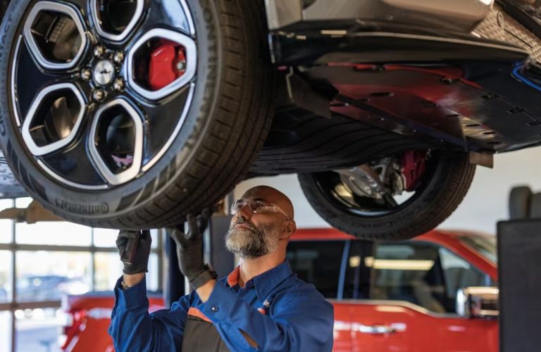 a technician working on a Ford car