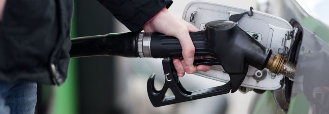Hand of a man fueling a vehicle