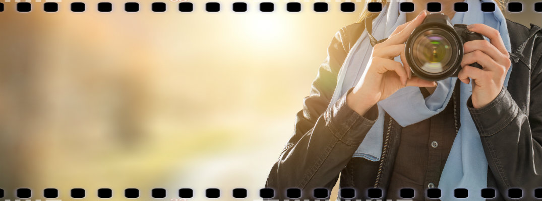 Woman holding a camera with film-style border
