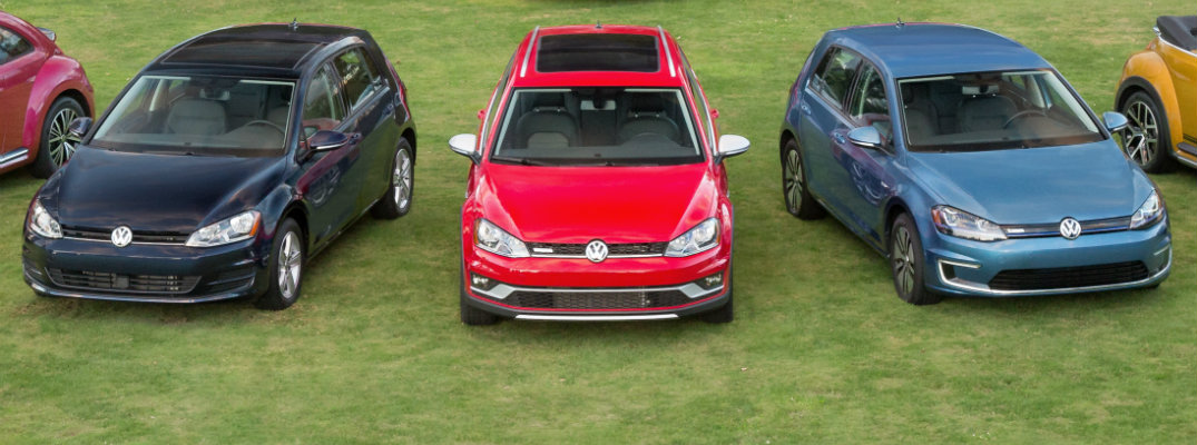 Volkswagen Golf models parked on grass
