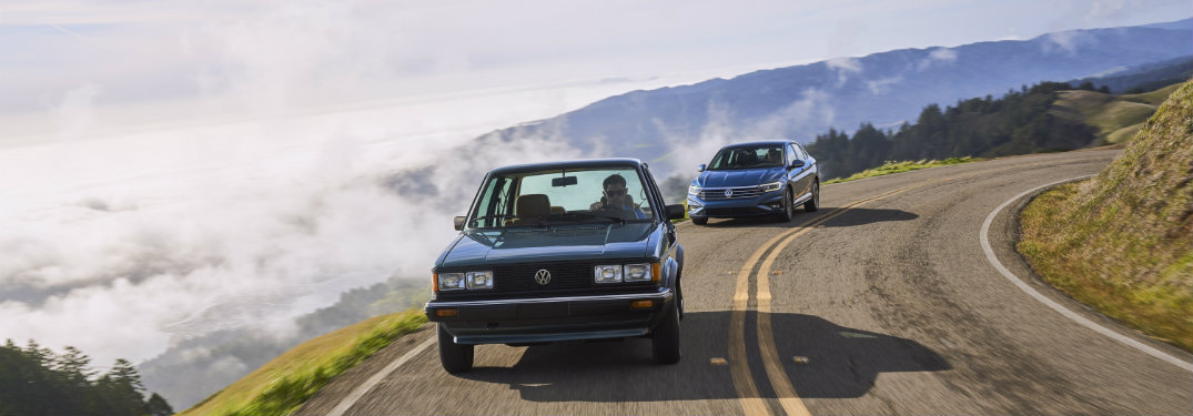 1982 Volkwagen Jetta and a 2019 Jetta driving together on a road