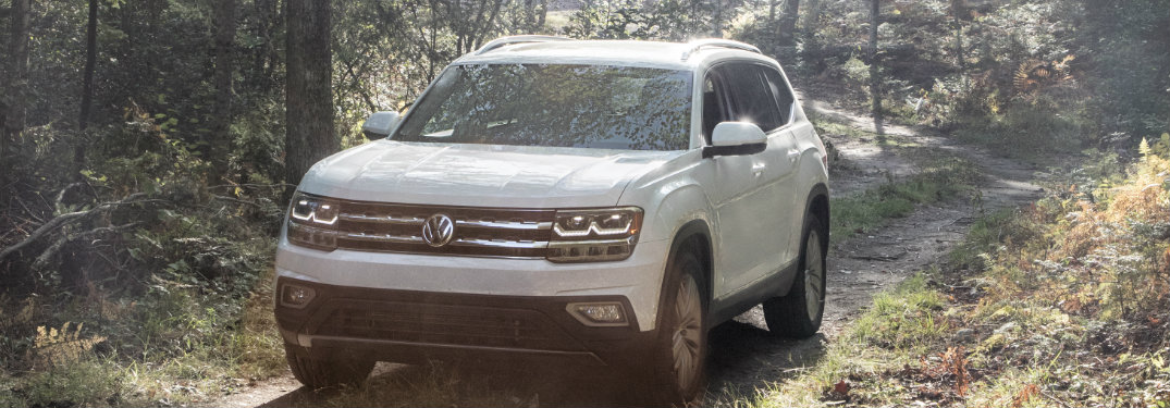 white 2018 VW Atlas driving through the forest
