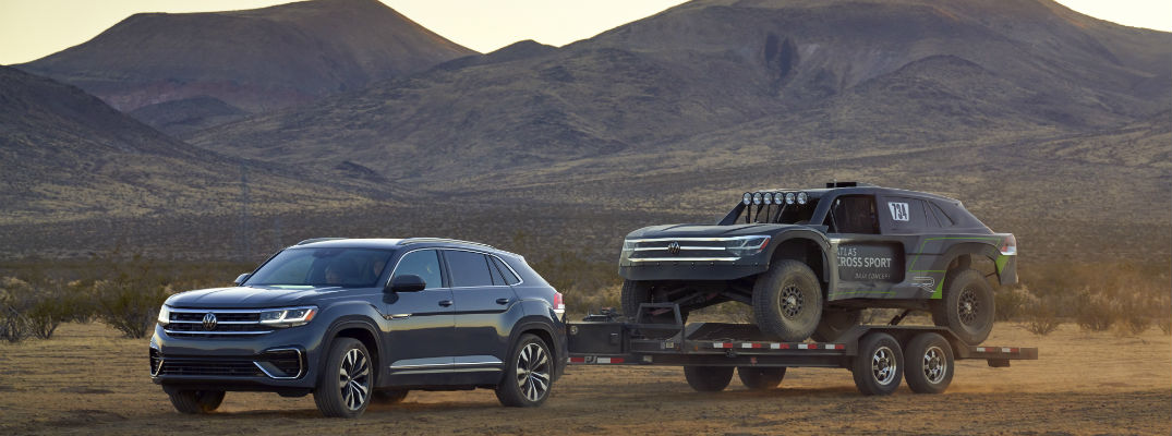 A photo of the Volkswagen Atlas Cross Sport pulling the rally racing version of the vehicle.