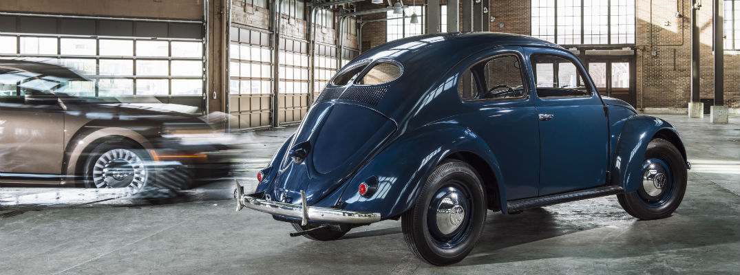 A photo of an original Volkswagen Beetle parked in a garage.