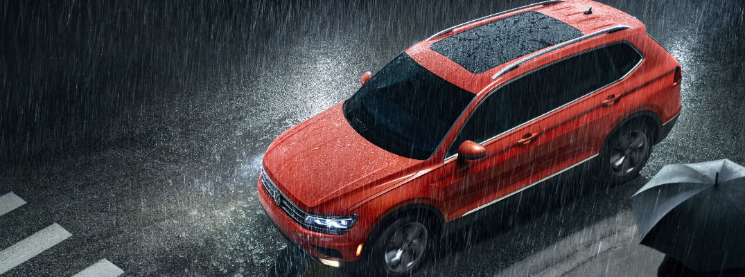 A photo illustration showing the 2020 Volkswagen Tiguan on a rain-covered street.