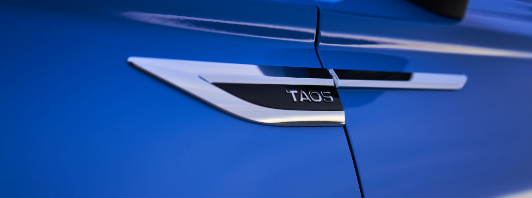 A photo of the Taos badge used on the 2022 VW Tiguan.