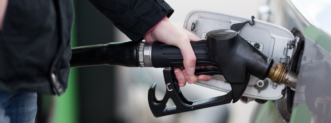 A stock photo of a person filling their vehicle with fuel.