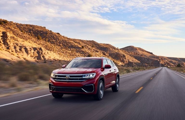 A red 2022 Volkswagen Atlas Cross Sport on the highway.