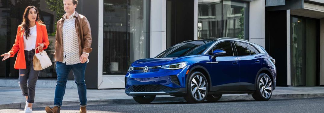 Man and woman walking away after parking the 2022 Volkswagen ID.4 EV