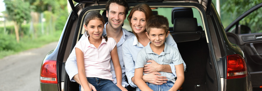 Family of four sitting in the back of their crossover