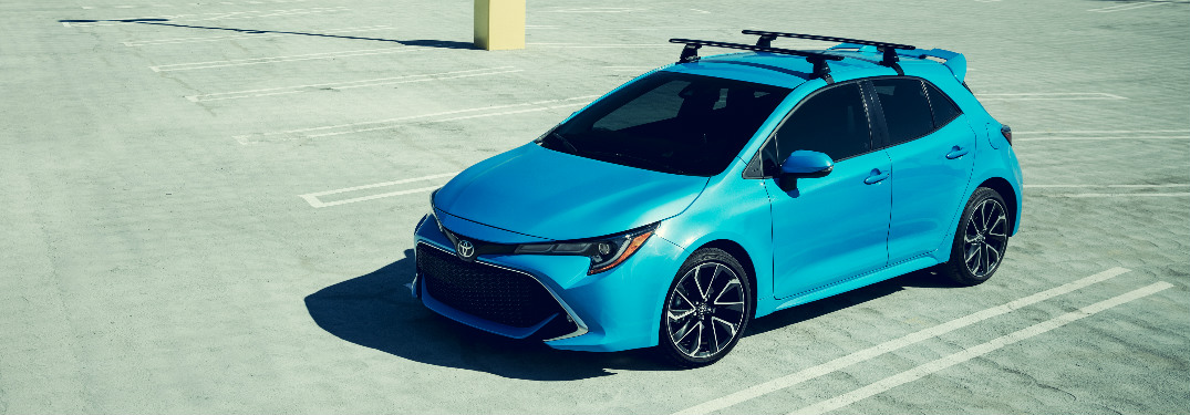 2019 Toyota Corolla Hatchback in bright blue sitting in an empty parking lot