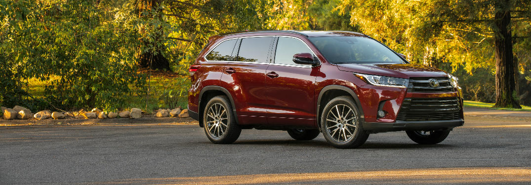 2018 Toyota Highlander parked in a paved lot in the woods