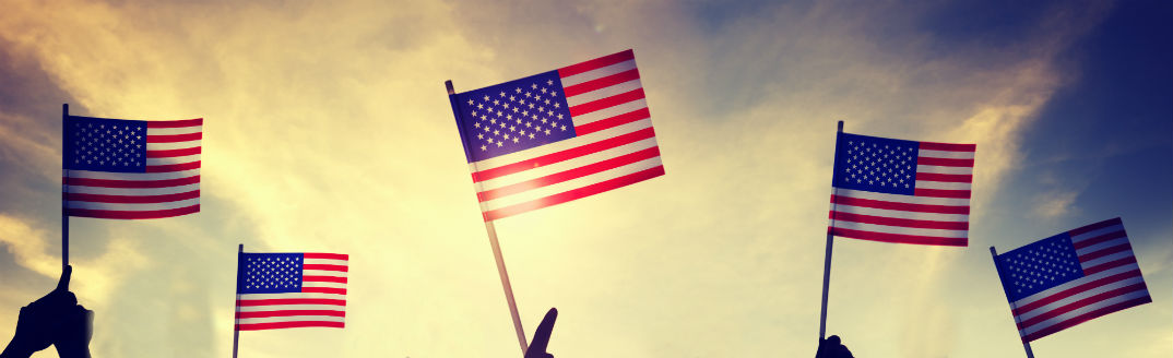 People waving american flags into the air