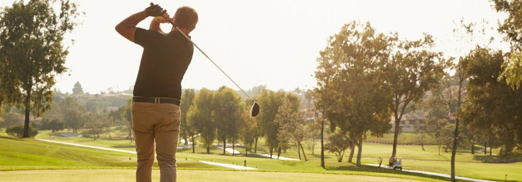 Man teeing off on the golf course