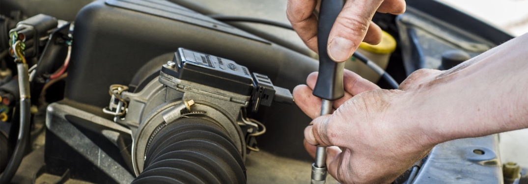 Man working under the hood of a car
