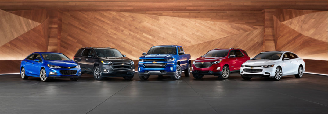 Chevy lineup with concrete floor and wood walls