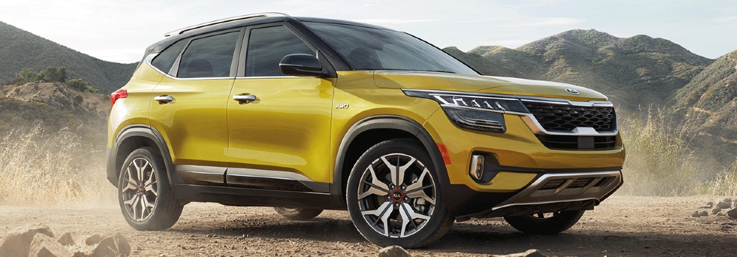 The front and side view of a yellow 2021 Kia Seltos.