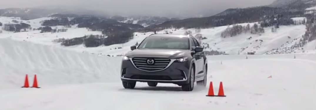 Grey Mazda CX-5 Driving on a Snowy Road