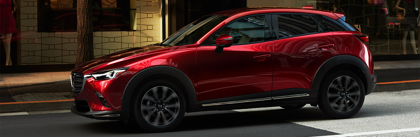 Exterior view of a red 2019 Mazda CX-3 parked on a city street