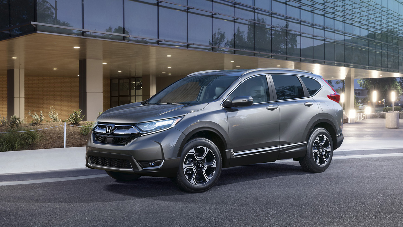 Image of a gray 2018 Honda CR-V parked in front of a glass building.