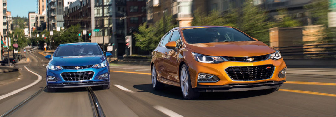 2018 Chevy Cruze sedan and hatchback driving on a road