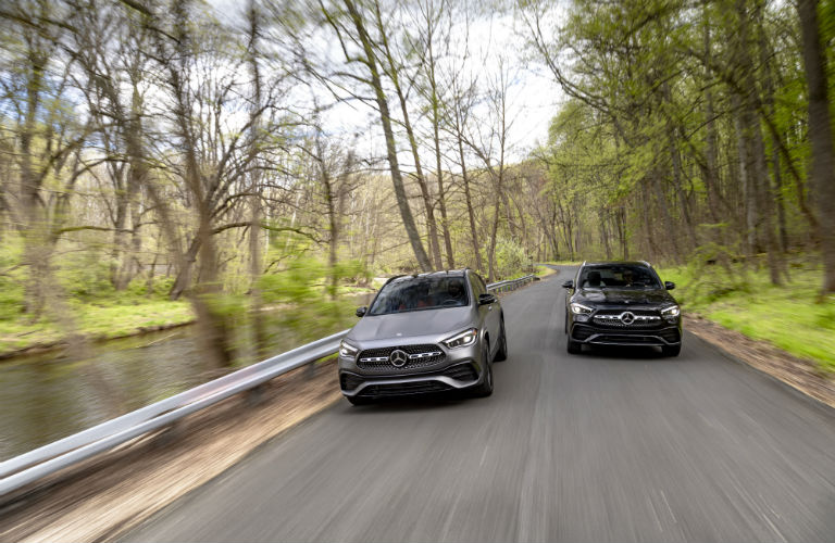 Two 2021 Mercedes-Benz GLA SUVs driving on a road