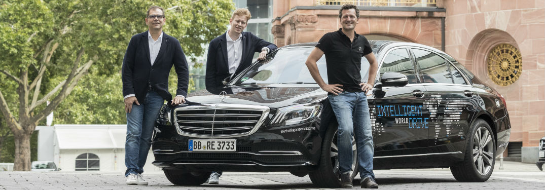 men standing in front of Mercedes-Benz Intelligent World Drive car