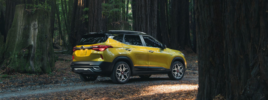 A rear right quarter photo of the 2021 Kia Seltos parked in the woods.