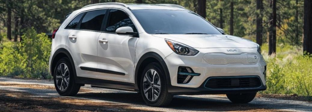 2022 Kia Niro EV parked on road between forest