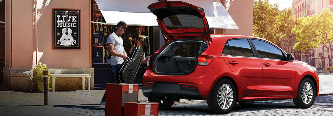 Man loading music equipment into his 2018 Kia Rio 5-Door