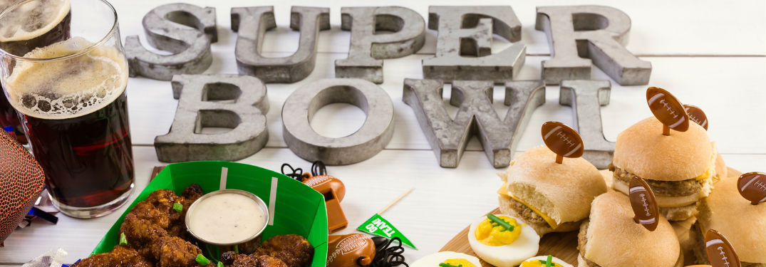 Table with drinks, food and Super Bowl lettering