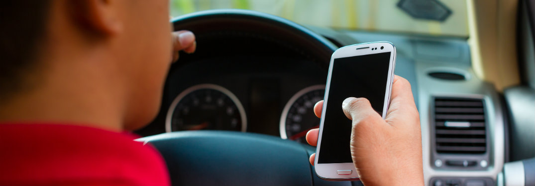 Man using smartphone in a car