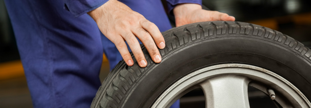 Man rolling a tire