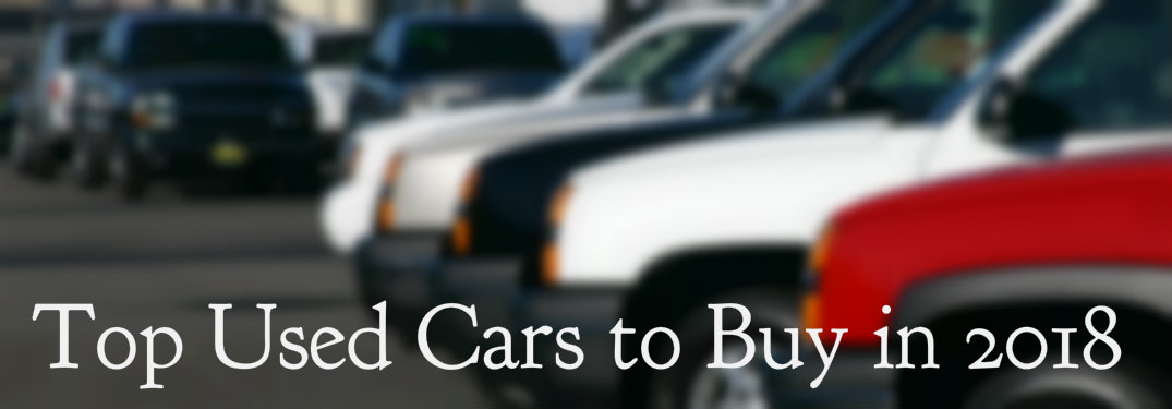 Top used cars text over blurred vehicles in dealership