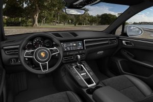 Interior of 2020 Porsche Macan showing front seat and dash and wheel