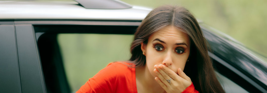 woman holding back puke