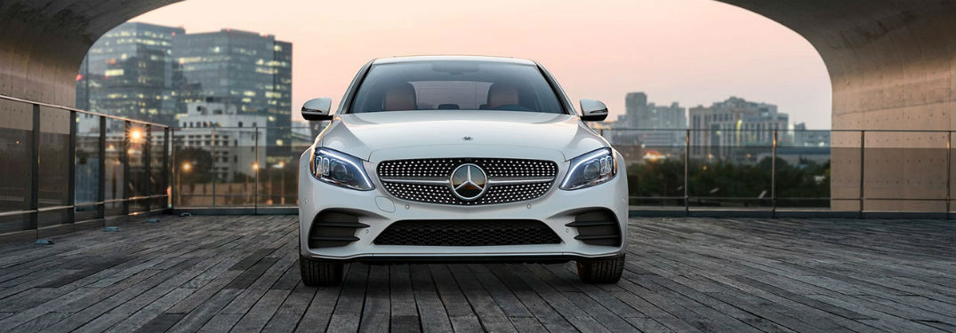2020 MB C Class sedan white exterior front fascia city background