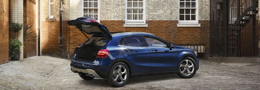 2018 Mercedes-Benz GLA 250 with the rear hatch open to the cargo area in front of a brick building