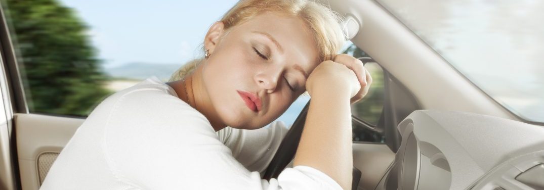 Young woman sleeping while driving
