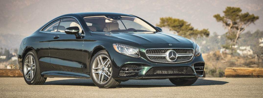 2018 Mercedes-Benz S 560 Coupe exterior shot parked on a gravel clearing with mountains in the background