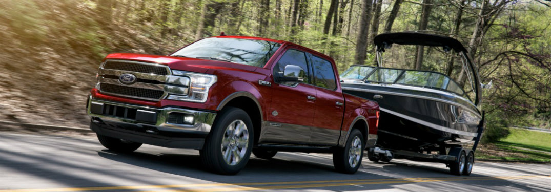 2018 Ford F-150 in red towing a boat