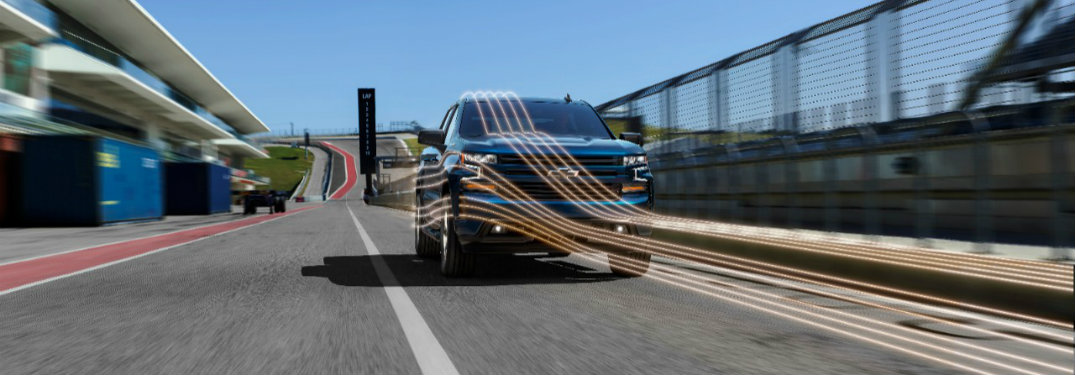 2019 Chevy Silverado driving on the road with lines showing where air currents flow around its grille and side